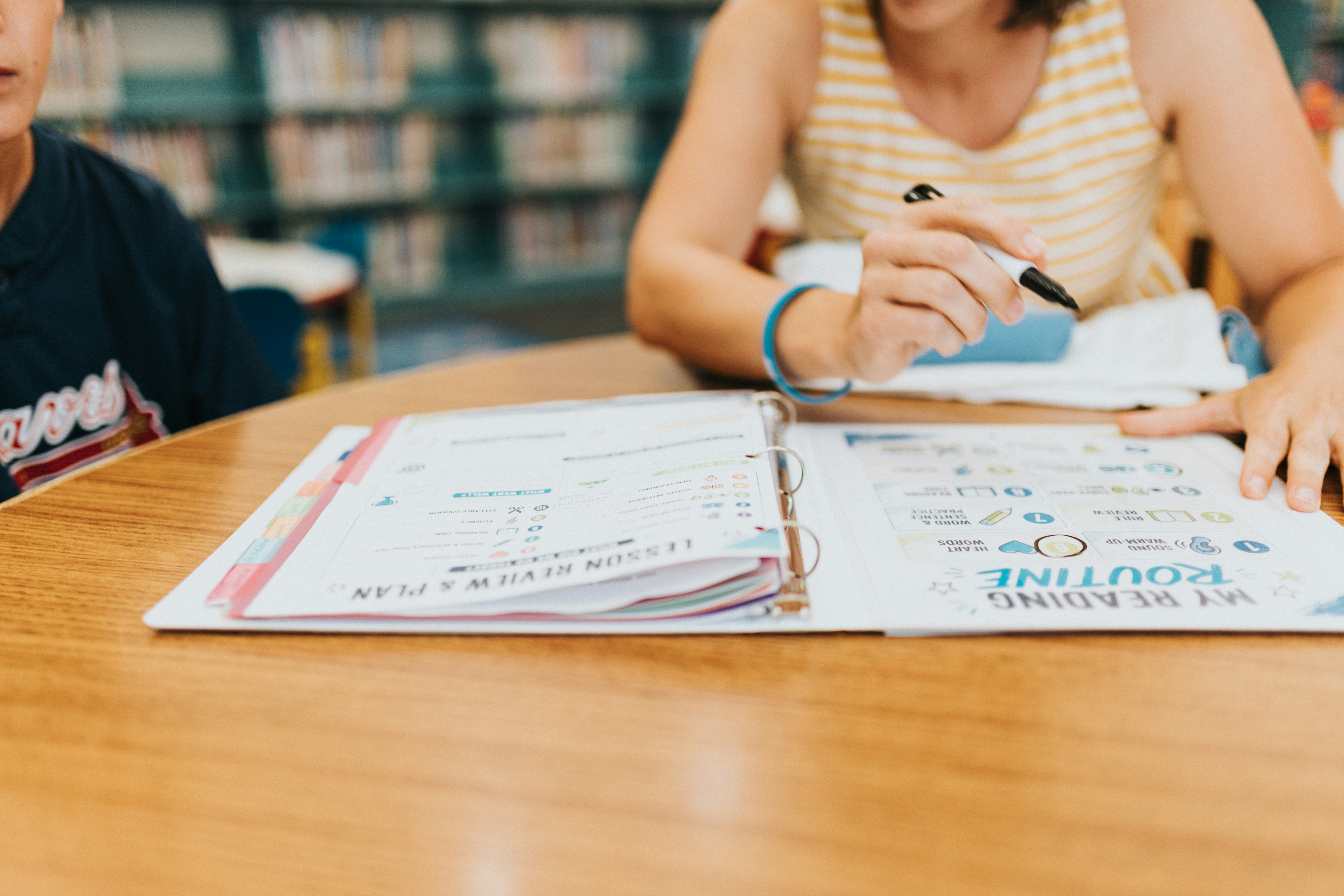 A tutor reviewing a lesson plan with a student